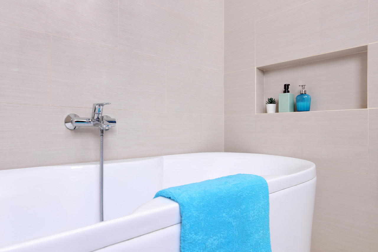A clean bathroom with a blue bathmat